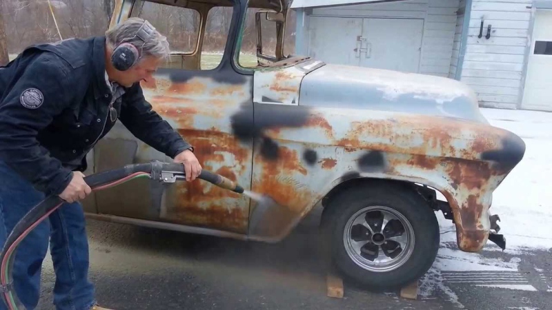Auto restoration by removing rust with sandblasting.